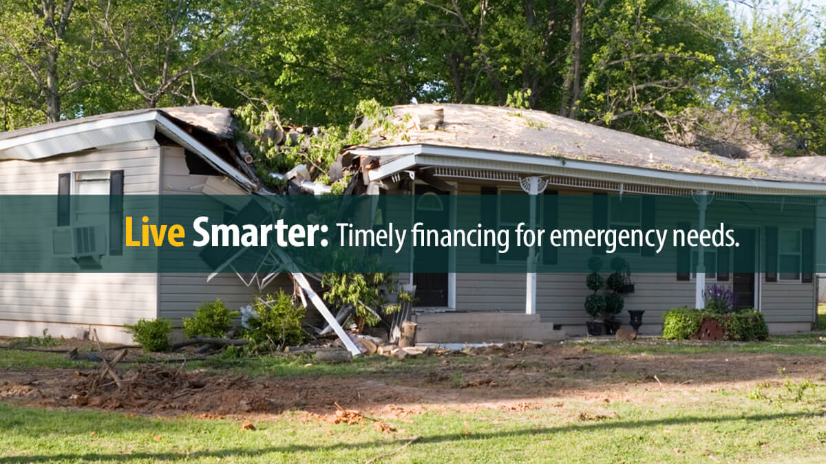 A damaged home after a large tree fell on it during a storm